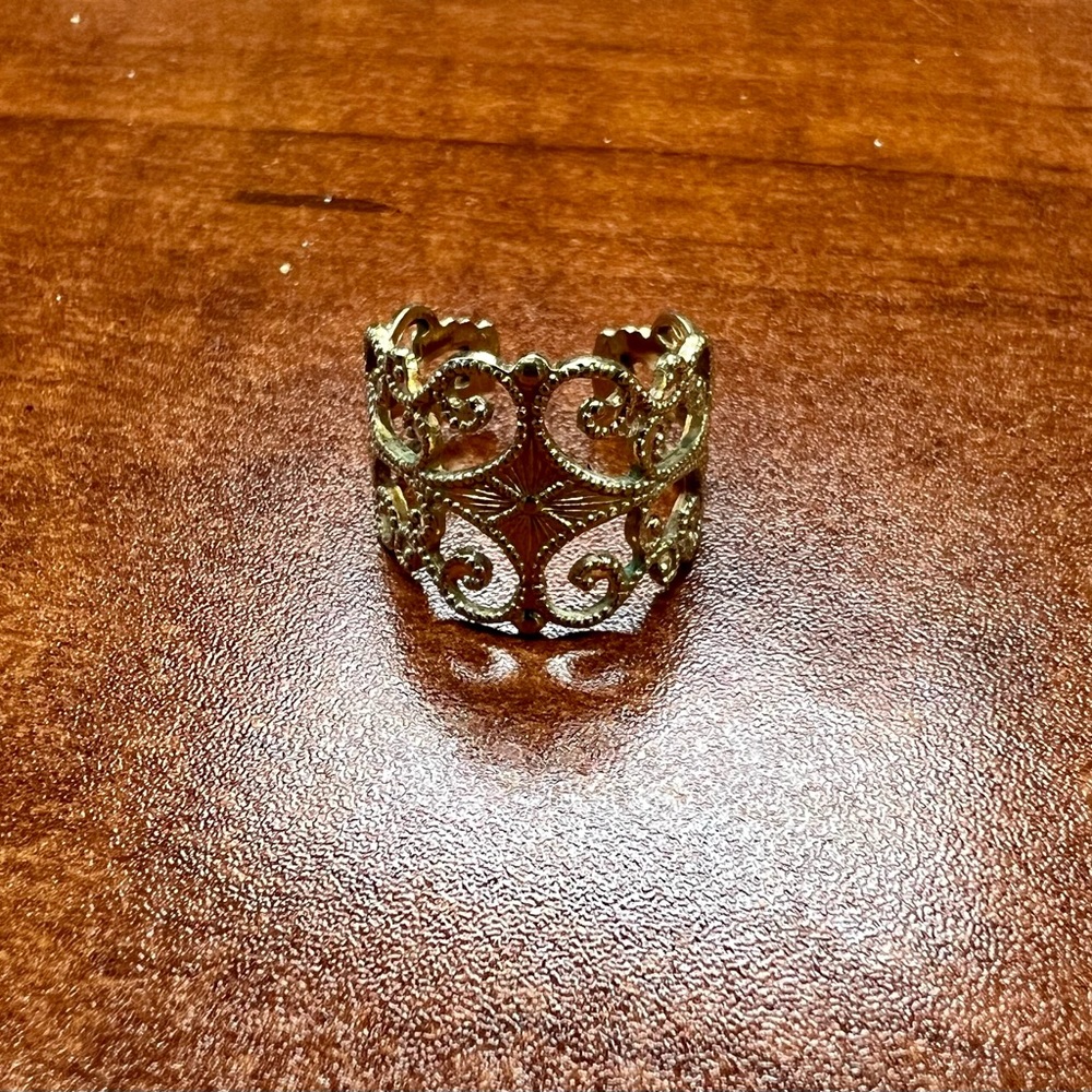 Gold Ring- costume jewelry. I believe it’s a size 5. “Sarah” inscribed